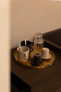 a tray with cups and saucers on a table at Spazio SIMA Space 2 - 2 in Milan
