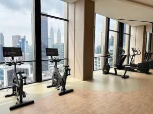 a gym with treadmills and exercise bikes in a building at Maxhome at Axon Bukit Bintang in Kuala Lumpur