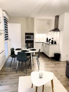 cocina y sala de estar con mesa y sillas en Hyper centre & parking privé - Le cocon T2 -Amiens, en Amiens