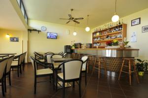 a restaurant with tables and chairs and a bar at Hotel Real in Cesenatico