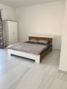 1 dormitorio con 1 cama y suelo de madera en CONFORT HOUSE, en Lugoj