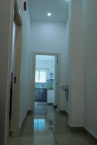a hallway leading to a kitchen with a sink at HISHAMS BHAVAN in Alwaye
