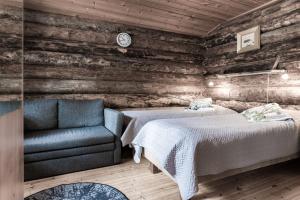 a bedroom with a bed and a couch at Holiday Village Himmerki in Posio
