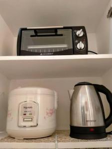 a toaster and a slow cooker in a refrigerator at Miestee's Happy Homes in Lapu Lapu City