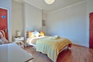 a bedroom with a bed and a chair in it at Fliss's House in Leicester