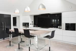 a kitchen with a wooden table and black chairs at Slate House in Ballybunion