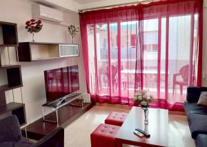 a living room with a couch and a table in front of a window at La Casella playa de Gandia in Playa de Gandia