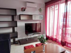 a living room with a television and a table at La Casella playa de Gandia in Playa de Gandia +5 photos