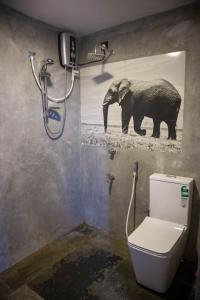a bathroom with a picture of an elephant on the wall at Boscage Homestay in Kandy