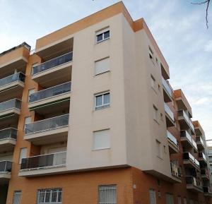 a tall building with balconies on the side of it at La Casella playa de Gandia in Playa de Gandia