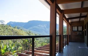 a view from the balcony of a house with mountains in the background at Pousada Boutique Raio de Luz in Ouro Preto