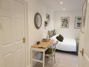 a room with a table and a bed and a bedroom at Fly By in Duxford