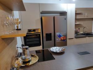 a kitchen with a stainless steel refrigerator and a counter at Private Parking-Top Retreat Residence in Vienna - Long Stays available in Vienna