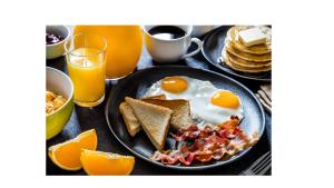 a plate of breakfast food with eggs and toast at Sun Star Villa Negombo in Daluwekotuwa