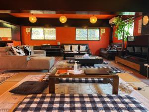 a living room with a couch and a table at Airport Osaka in Kaizuka