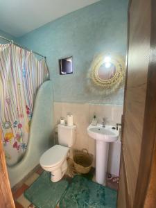 a small bathroom with a toilet and a sink at Dar Koujane Petite maison isolée avec piscine privée 