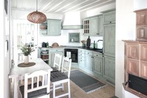 a kitchen with green cabinets and a table and chairs at Casa Palfy in Oslip