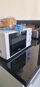 a microwave sitting on top of a counter at Hillend Self-Catering in Portree +17 photos