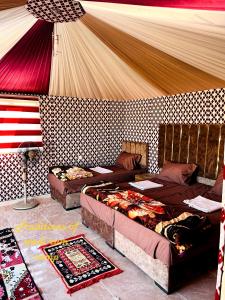 a room with two beds and an american flag at Traditions of Wadi Rum camp & jeep tour in Wadi Rum