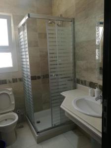 a bathroom with a shower and a toilet and a sink at Your Perfect Getaway with a Breathtaking Beach View in Ain Sokhna