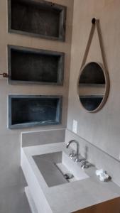 a bathroom with a sink and a mirror at Pousada Boutique Raio de Luz in Ouro Preto
