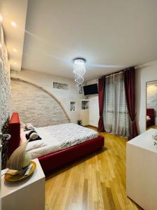 a bedroom with a large bed and a brick wall at Serendipity in Bentivoglio