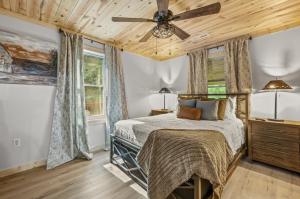 a bedroom with a bed and a ceiling fan at Hidden Forest Spa Sauna Nature Secluded 93 acres in Sevierville