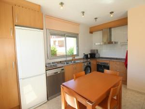 a kitchen with a wooden table and a dining room at Apartamento Llançà, 2 dormitorios, 5 personas - ES-228-74 in Llança