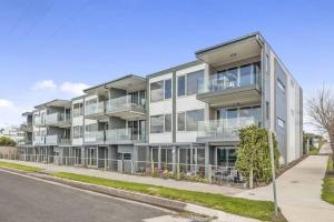 an apartment building with balconies on a street at Bay Vue - Absolute Oceanviews in Apollo Bay