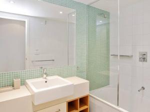 a white bathroom with a sink and a shower at Bay Vue - Absolute Oceanviews in Apollo Bay +17 photos