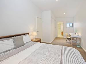 a bedroom with a large bed and a desk at Bay Vue - Absolute Oceanviews in Apollo Bay