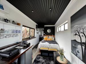 a bedroom with a bed and a desk in a room at Into The Mystic in Cape Town