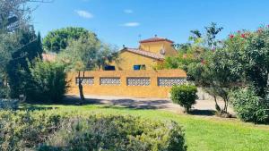 ル・バルカレスにあるMagnifique Maison avec piscine privée à 300 m d'une trés jolie plage de sableの庭の黄柵のある家