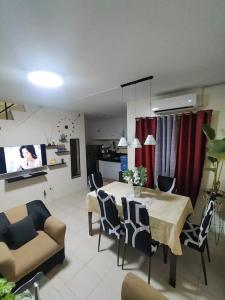 a kitchen and living room with a table and chairs at Miestee's Sweet Home in Lapu Lapu City
