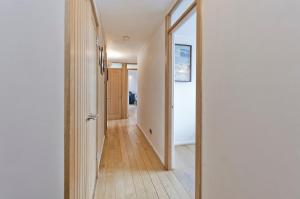 a hallway of a house with a mirror at ALTIDO Charming flat overlooking River Thames in London