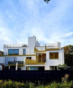 a white building with a balcony on top of it at Private Parking-Top Retreat Residence in Vienna - Long Stays available in Vienna