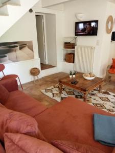 a living room with a couch and a table at Domaine du Moulin de Cors in La Roque-sur-Cèze