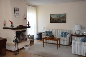 a living room with two couches and a fireplace at Casa Palmira in Pescocostanzo