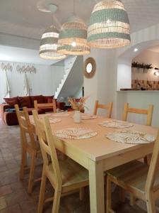a dining room with a wooden table and chairs at Domaine du Moulin de Cors in La Roque-sur-Cèze