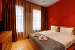 a bedroom with a bed with two towels on it at Urban Apartments 23 in Tbilisi City