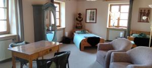a bedroom with a bed and a table and chairs at Apartments Angela in Wiesau