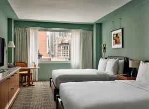 a hotel room with two beds and a window at Romer Hell's Kitchen in New York