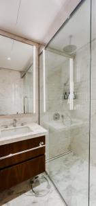 a bathroom with a shower and a sink at AYA Boutique - Cozy 1BR Apartment with Panoramic City Views in Dubai