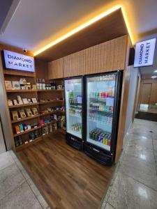 a pharmacyacist with a refrigerator in a store at Nobile Suites Diamond in Vitória