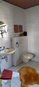 a white bathroom with a sink and a toilet at Apartments Angela in Wiesau +38 photos