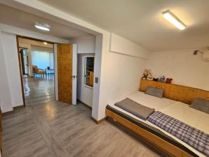 a bedroom with a large bed with a wooden headboard at Today Jeju Yongdam in Jeju