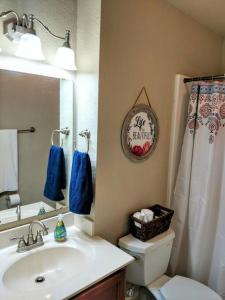 a bathroom with a sink and a toilet and a mirror at Perfect Lake Retreat in Hot Springs