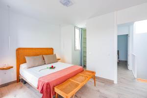 a bedroom with a bed with a table on it at VILLA MARACUYÁ in Tías +29 photos