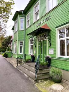 a green building with stairs in front of it at Green Villa in Pärnu