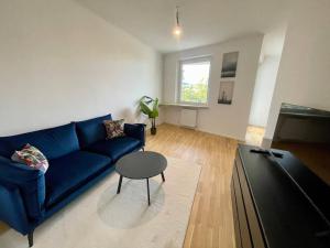 uma sala de estar com um sofá azul e uma mesa em U4 Spittelau TR10 em Viena